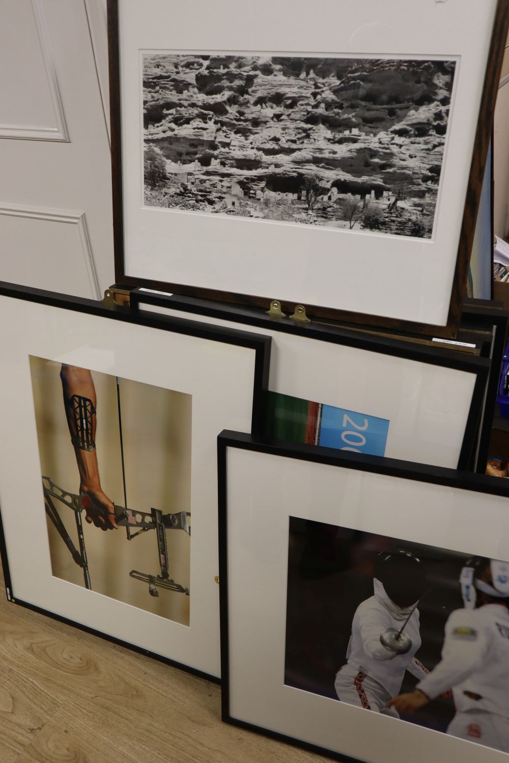 A collection of eight contemporary photographs of Olympians, approximately 40 x 58cm and two other black and white photographs